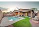 Beautiful backyard with a sparkling pool, covered patio, and well-manicured landscaping, ideal for outdoor enjoyment at 7235 Summer Air Ave, Las Vegas, NV 89179