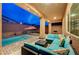 Covered patio area with outdoor seating, string lights, and a backyard splash pool at 7235 Summer Air Ave, Las Vegas, NV 89179