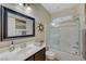 Well-lit bathroom featuring a vanity, tub, and a framed glass shower door at 7235 Summer Air Ave, Las Vegas, NV 89179