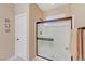 Modern shower with glass door and bronze fixtures at 7235 Summer Air Ave, Las Vegas, NV 89179
