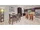 Dining area with a dining table, pendant lighting, and dark cabinets at 7235 Summer Air Ave, Las Vegas, NV 89179