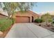 Attractive single-story home featuring desert landscaping, a two-car garage, and a paved driveway at 7235 Summer Air Ave, Las Vegas, NV 89179