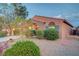 Inviting single-story house with manicured desert landscaping, and an arched entryway at 7235 Summer Air Ave, Las Vegas, NV 89179