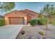 Beautiful single-story house with desert landscaping, a two car garage, and an arched entryway at 7235 Summer Air Ave, Las Vegas, NV 89179