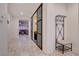 Bright foyer featuring stylish coat rack and decorative glass block wall with a view into a cozy living room at 7235 Summer Air Ave, Las Vegas, NV 89179