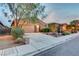 Charming single-story home showcasing desert landscaping and a two-car garage at dusk at 7235 Summer Air Ave, Las Vegas, NV 89179