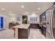 Modern kitchen featuring an island with bar stool seating, stainless steel appliances, and ample storage at 7235 Summer Air Ave, Las Vegas, NV 89179