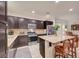Modern kitchen showcasing an island with bar stool seating, stainless steel appliances, and ample storage at 7235 Summer Air Ave, Las Vegas, NV 89179