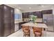 Bright kitchen featuring a large island, dark cabinets, granite countertops, and stainless appliances at 7235 Summer Air Ave, Las Vegas, NV 89179