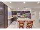 Well-lit kitchen featuring dark wood cabinets, a large island, and stainless steel appliances at 7235 Summer Air Ave, Las Vegas, NV 89179