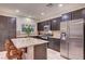 Stylish kitchen with dark cabinets, granite countertops, stainless steel appliances, and tile flooring at 7235 Summer Air Ave, Las Vegas, NV 89179