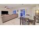 Open-concept living room and dining area with modern decor, tile floors, and access to outdoor patio at 7235 Summer Air Ave, Las Vegas, NV 89179