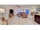 Open-concept living room featuring a comfortable sectional sofa, a ceiling fan, and sliding door access to patio at 7235 Summer Air Ave, Las Vegas, NV 89179