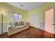 Cozy living room features a comfortable couch, wood floors, and ample closet space at 7235 Summer Air Ave, Las Vegas, NV 89179