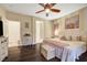 Well lit primary bedroom with a ceiling fan and hardwood floors at 7235 Summer Air Ave, Las Vegas, NV 89179