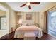 Bright primary bedroom with large window, ceiling fan and decorative striped wall at 7235 Summer Air Ave, Las Vegas, NV 89179