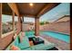 Cozy backyard with a refreshing pool, covered patio, and comfortable outdoor sectional seating at 7235 Summer Air Ave, Las Vegas, NV 89179