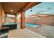 Inviting backyard featuring a sparkling pool, covered patio, and comfortable outdoor seating area at 7235 Summer Air Ave, Las Vegas, NV 89179