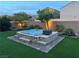 Stunning backyard with a jacuzzi, artificial grass, and privacy landscaping; great for relaxing! at 7424 Rainford St, Las Vegas, NV 89148