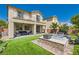 Inviting backyard featuring a spa, patio, well-manicured landscaping, and outdoor seating at 7424 Rainford St, Las Vegas, NV 89148