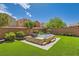 Relax in a tranquil backyard with a built-in hot tub, lush landscaping, and cozy seating at 7424 Rainford St, Las Vegas, NV 89148