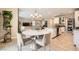 Open-concept dining area featuring a stylish chandelier, round table, and access to the kitchen and living room at 7424 Rainford St, Las Vegas, NV 89148