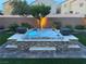 Backyard hot tub boasts stone accents, ambient lighting, and privacy wall for relaxing outdoor living at 7424 Rainford St, Las Vegas, NV 89148