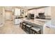 Well-lit kitchen featuring a large island with seating, stainless steel appliances, and white cabinetry at 7424 Rainford St, Las Vegas, NV 89148