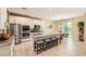 Bright, spacious kitchen with stainless steel appliances, granite countertops, and a large center island at 7424 Rainford St, Las Vegas, NV 89148