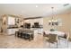 Open-concept kitchen with granite island, stainless steel appliances, and dining area at 7424 Rainford St, Las Vegas, NV 89148