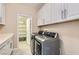 Convenient laundry room with modern appliances and ample storage space, plus access to the storage room at 7424 Rainford St, Las Vegas, NV 89148