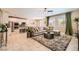 Open-concept living area with modern sofa, kitchen, and bright windows at 7424 Rainford St, Las Vegas, NV 89148