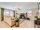 Inviting living room with comfortable sofa, neutral colors, and tile flooring at 7424 Rainford St, Las Vegas, NV 89148