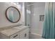 Updated bathroom boasts a new sink vanity and tiled shower with a shower curtain at 75 N Valle Verde Dr # 211, Henderson, NV 89074