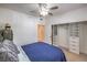 Bright bedroom features a ceiling fan and large closet with custom shelving at 75 N Valle Verde Dr # 211, Henderson, NV 89074