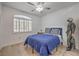 Bedroom with wood floors, shuttered window, blue bedding and unique decor at 75 N Valle Verde Dr # 211, Henderson, NV 89074