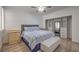 Bedroom featuring a comfortable bed, modern furnishings, wood floors, and organized closet space at 75 N Valle Verde Dr # 211, Henderson, NV 89074