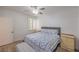 Bright bedroom with white walls, ceiling fan, wood floors, and a window with shutters at 75 N Valle Verde Dr # 211, Henderson, NV 89074