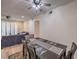 View of the dining area with hardwood floors, table and chairs, ceiling fan and view into living area at 75 N Valle Verde Dr # 211, Henderson, NV 89074