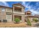 View of the condo complex featuring private balconies, red tile roof, and well-kept landscaping at 75 N Valle Verde Dr # 211, Henderson, NV 89074