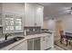 Updated kitchen featuring stone counters, stainless appliances and view into dining and living areas at 75 N Valle Verde Dr # 211, Henderson, NV 89074
