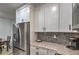 Bright kitchen showcasing white cabinets, granite counters, stainless steel appliances at 75 N Valle Verde Dr # 211, Henderson, NV 89074