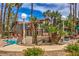 Serene community pool area with comfortable lounge chairs and lush landscaping, all under a sunny sky at 75 N Valle Verde Dr # 211, Henderson, NV 89074