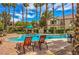 Beautiful community pool with lounge chairs for relaxation, all surrounded by lush trees at 75 N Valle Verde Dr # 211, Henderson, NV 89074