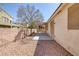 Backyard with a covered patio, neutral stucco exterior, desert landscaping, and a block wall for privacy at 7544 Coral River Dr, Las Vegas, NV 89131