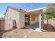 The backyard has a covered patio, desert landscaping, neutral stucco exterior, and a privacy fence at 7544 Coral River Dr, Las Vegas, NV 89131