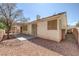 The backyard features a covered patio, low-maintenance desert landscaping, and a neutral stucco exterior at 7544 Coral River Dr, Las Vegas, NV 89131