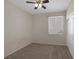 A carpeted bedroom features a ceiling fan and a window for natural light at 7544 Coral River Dr, Las Vegas, NV 89131