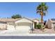 Inviting single-story home featuring a three-car garage and desert landscaping at 7544 Coral River Dr, Las Vegas, NV 89131