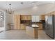 Spacious kitchen with stainless steel appliances, an island, granite counters, and natural light at 7544 Coral River Dr, Las Vegas, NV 89131